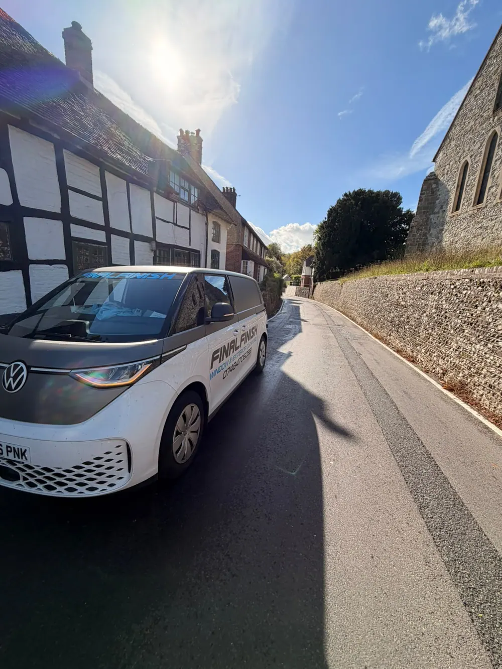 Final Finish cleaning van parked in a quiet village lane beside a flint wall